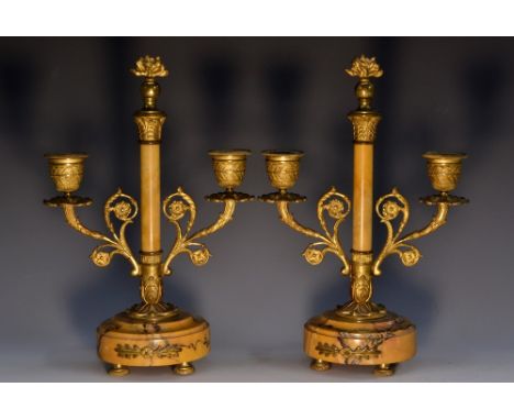 A pair of 19th century French ormolu and Sienna marble three-light candelabra, flaming grenade finials, lotus cast sconces, d