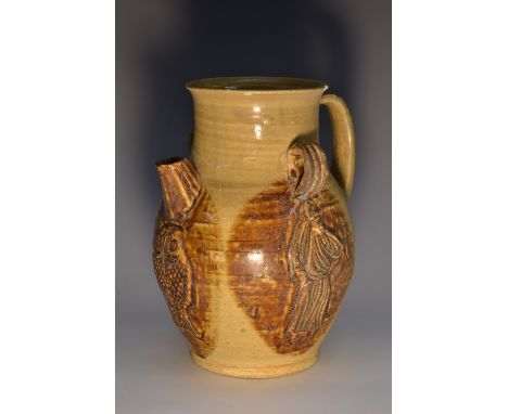 A Chinese baluster earthenware ewer, moulded in relief with figures and a fish, each glazed in mottled tones, short spout fla