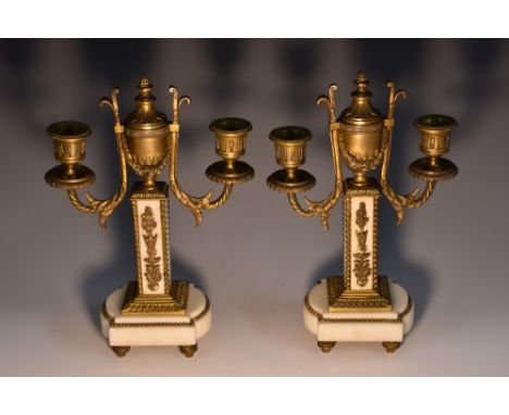 A pair of 19th century ormolu and white marble mantel cassolette candelbra, each urnular cresting with acanthus bud finial en