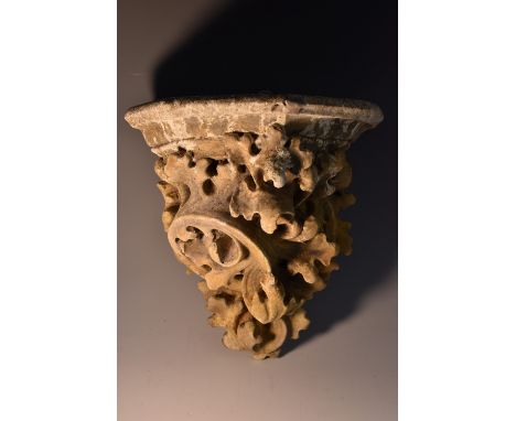 A Victorian Coade stone-type composite architectural corbel, moulded in low relief with scrolling fern leaves, canted plateau