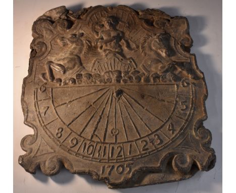 A lead sundial, in relief with Apollo in his chariot, heralding the dawn, above a demi-lune scale, 30cm wide, dated 1705 