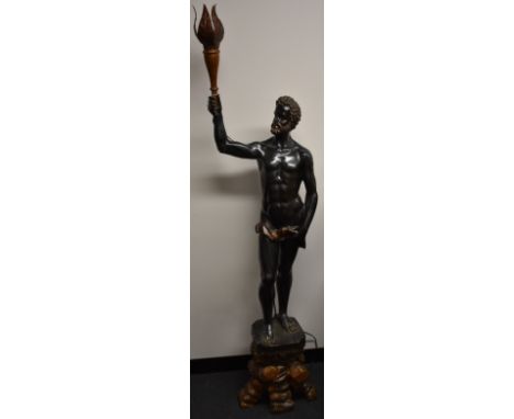 A Neo-Baroque painted composition blackamoor lamp, scantily clad bearded Nubian stands, a torch raised aloft in his hand, can