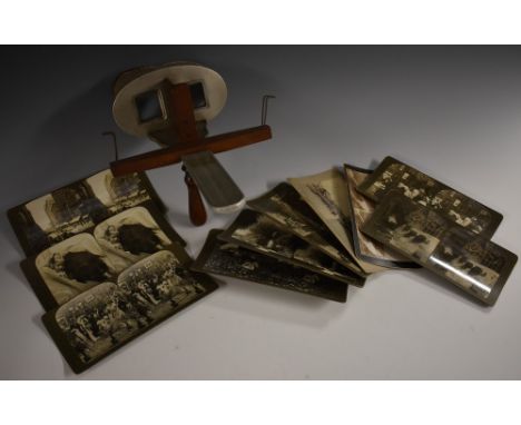 A late 19th century mahogany and aluminium hand-held stereoscope, retailed by The Fine Art Photographers Publishing Co., Lond