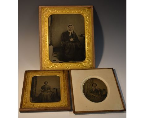 Photography - a 19th century ambrotype portrait, of a young lady, seated by a table, books within her reach, 13cm x 10, chase