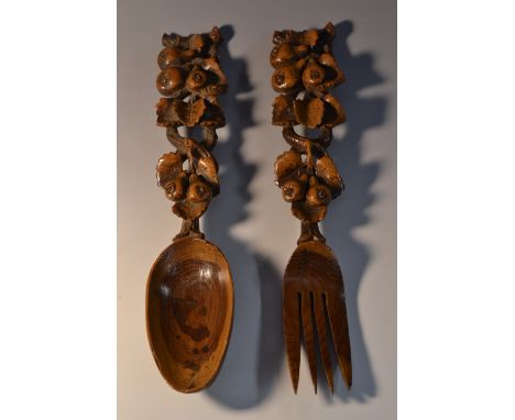 Treen - a 19th century fruitwood spoon and fork, each stem carved with branches laden with pears, 25cm long