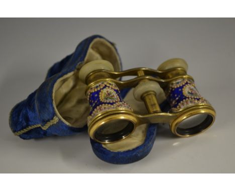 A pair of 19th century French enamel opera glasses, brightly decorated with sprays of colourful summer flowers on a blue grou