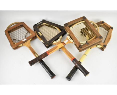 A small collection of four vintage tennis rackets, comprising Slazengers, Aldershot and Dunlop, all with press frame 