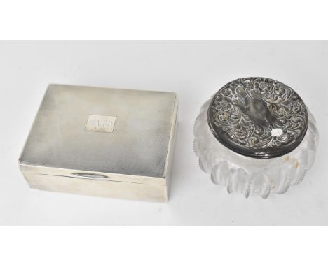 A 20th century silver cigarette box, Birmingham 1964, of rectangular form, the hinged lid with engine turned detail, opening 