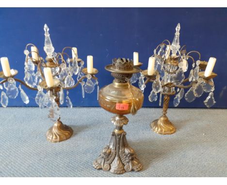 A pair of table top candelabras with glass droplets, 5-arm, together with a Victorian cast iron oil lamp with amber glass res