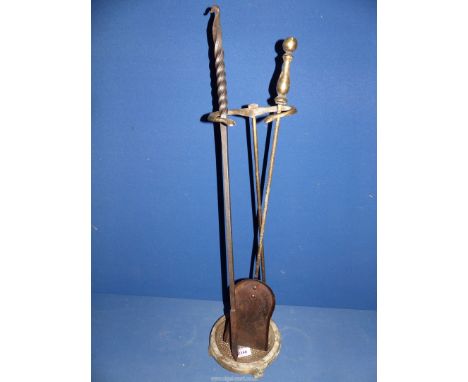 A brass finished Companion stand with poker and shovel.