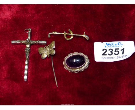 An Italian made crucifix, unmarked polished stone brooch, hunting stick pin, etc.