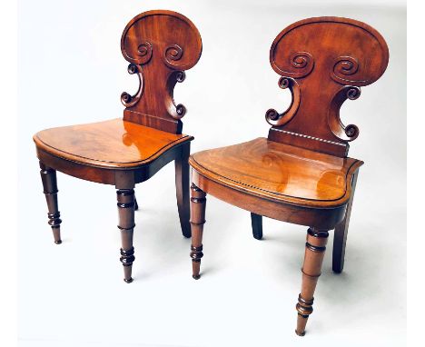 HALL CHAIRS, a pair, Regency mahogany with scroll backs bow panel seat and turned front supports. (2)