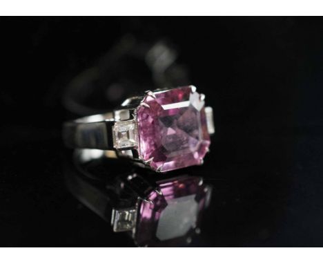 A FINE RED TOURMALINE AND DIAMOND DRESS RING, the square cut cornered Tourmaline, weighing 7.4 carats, set with square cut si