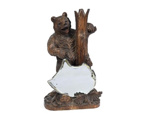 BLACK FOREST BEAR - MIRROR a large figure of an upright bear, leaning against a tree trunk and with foliage around the base. 