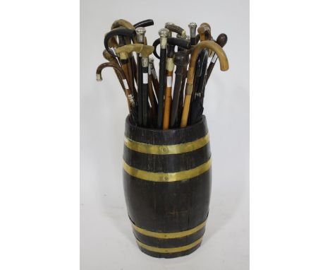 OAK STICK BARREL &amp; LARGE QTY OF WALKING STICKS an oak and brass bound barrel stick stand (61cms high), with a large qty o