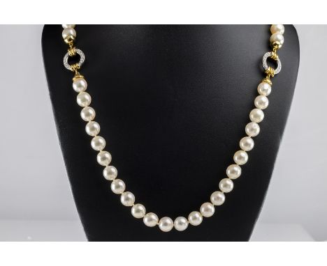 Taverna Gioielli: an 18ct yellow and white gold cultured pearl and diamond necklace,  the knotted string of approx 8.5mm pear