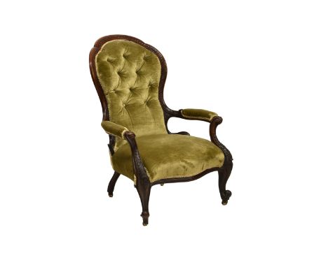 An early Victorian carved walnut showframe open armchair  with a carved back and scroll carved padded arms on heavily carved 