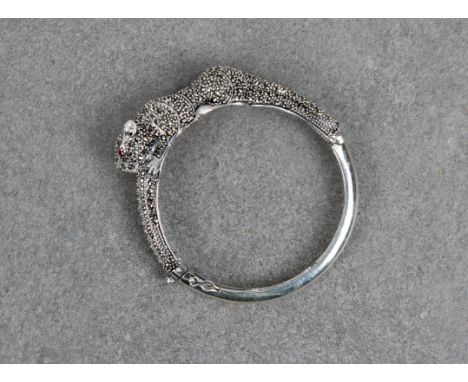 A silver and marcasite hinged bangle,  in the form of a panther, pave-set with marcasites and ruby eyes, internal diam approx