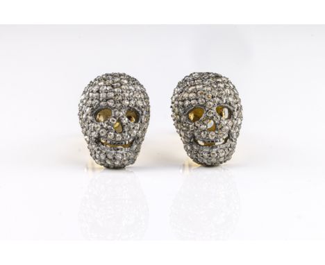 A pair of silver-gilt and diamond novelty cufflinks,  in the form of skulls, pave-set rose-cut diamonds throughout, total dia