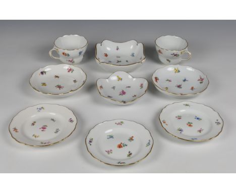 Two 20th century Meissen cups and saucers  with floral decoration and gilded rims along with associated pair of side plates a