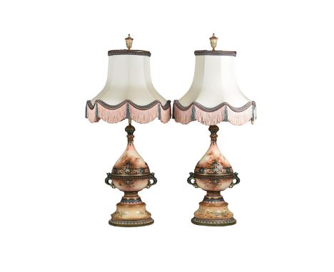 A pair of Royal Worcester porcelain lamps  of baluster form with painted floral and gilded decoration, each with a pair of dr