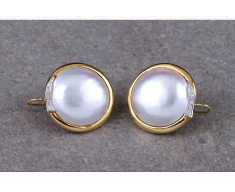 A pair of Italian 18 carat gold Mabé pearl and diamond earrings  each with a central Mabé pearl, approx. 23mm. diameter, in a