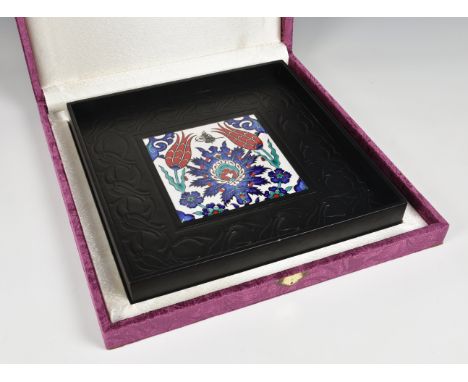 A De Lamerie of London presentation, hand painted, ceramic tile set in a black embossed leather tray,  inscribed on back of f