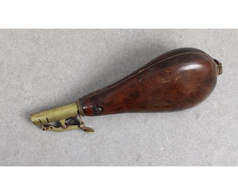 A Dixon &amp; Sons leather and brass shot flask  typical form, spring hinge opening.  