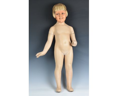Advertising - a 1920s-30s child shop display mannequin  in painted composition, the head with painted face and hair and glass