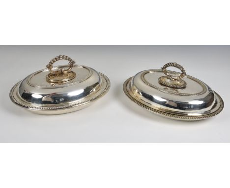 Two oval silver plated lidded serving dishes  with detachable handles, 11in. (27.9cm.) long.  