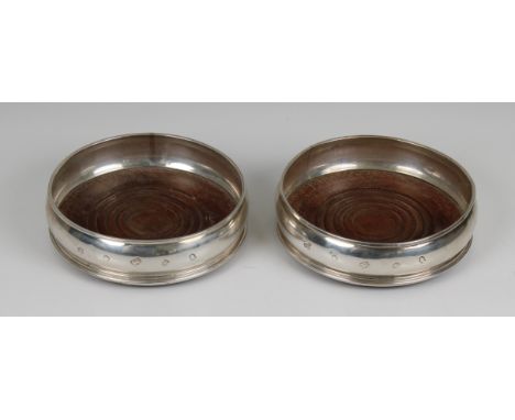 A pair of Elizabeth II silver wine coasters  A. Chick &amp; Sons Ltd, London, 1977, of bellied circular form with turned wood