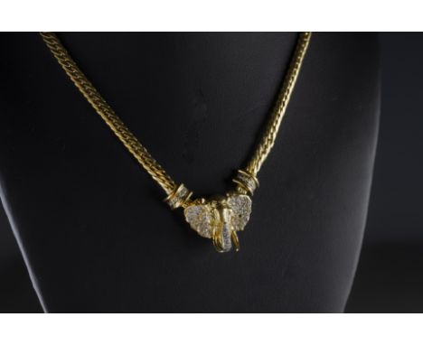 An 18k yellow gold and diamond 'elephant' necklace,  the yellow gold cast elephant's head set with forty-two round brilliant-