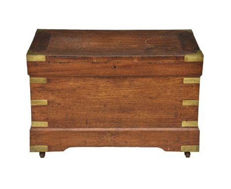 A late 19th / early 20th century mahogany and brass trunk  the hinged lid opening to storage, raised on a plinth base with br