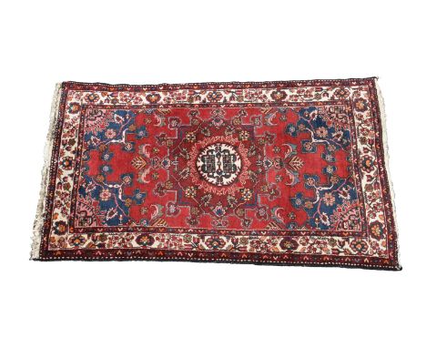 A Tafresh rug, north west Persia  the 'clock-face' medallion with conforming spandrels, flanked by meandering carnation minor