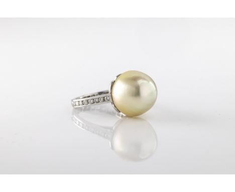 A white gold South Sea pearl and diamond dress ring,  the large pearl approx 15mm x 14mm, on a white gold shank, unmarked ass