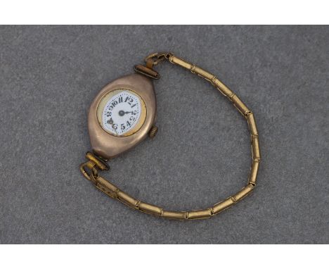 An antique 9ct rose gold cased ladies wrist watch  hallmarked London 1915, the manual wind movement fronted by a tonneau shap