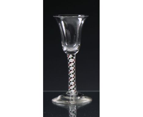 A fine mid-18th century colour twist wine glass  c.1765, the bell shaped bowl on a multi-series colour twist stem, with white