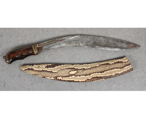 A Kukri with unusual and rare snake skin scabbard  brass bound wooden hilt, 33cm. steel blade.  