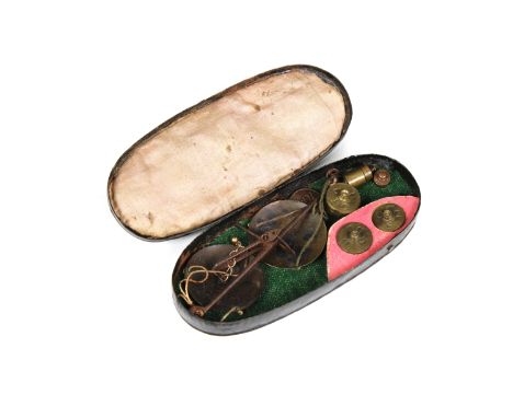 A set of steel, hanging, pocket-scales and weights, circa 1800, in an oval, black tole ware case, the beam 4¼ in. (10.8 cm.) 