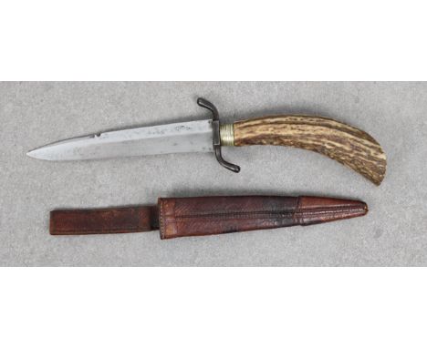 An Imperial German trench knife  having 5 3/8in. (13.7cm.) S shaped crossguard, double edged steel blade, horn grip, leather 