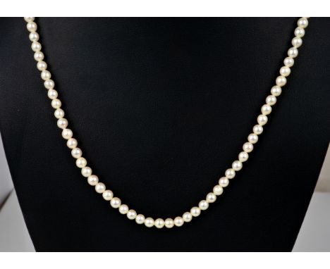 A cultured pearl single strand necklace  the evenly sized 4mm. pearls with 18ct gold clasp, 19in. (48.25cm.) long.  