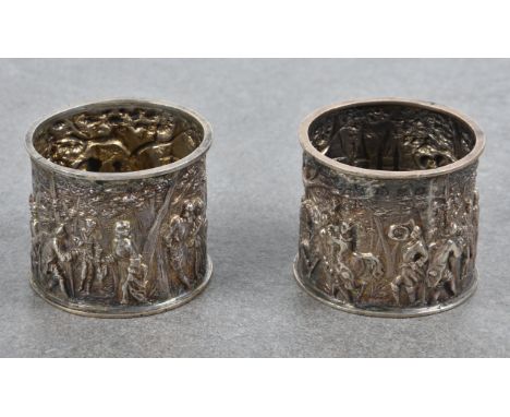 A pair of elegant Victorian parcel gilt silver repoussé napkin rings  Haseler Brothers, Birmingham, 1897, each depicting figu