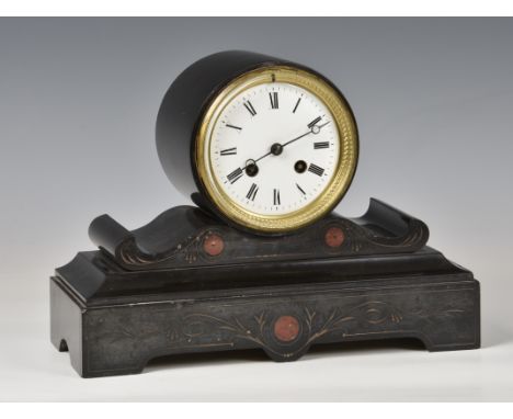 A late 19th century black slate drum clock  the white Roman enamel dial with blued steel hands and brass bezel, above scrolli