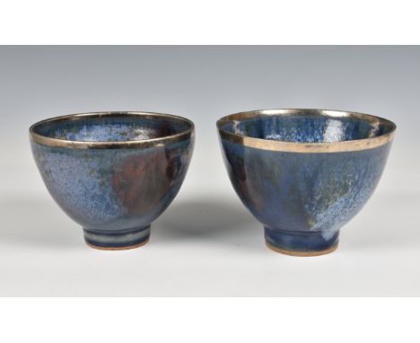 Studio Pottery, a pair of blue glazed ceramic footed bowls with silvered rims  stamped marks beneath "EC" 6in. (15.2cm.) diam