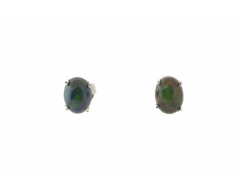 A pair of silver and Ethiopian black opal stud earrings,  the oval cabochon opals in four-claw settings, post and butterfly f