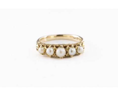 A vintage 18ct gold and five pearl ring  the carved scroll setting holding five graduated pearls, marked '18ct', size L.  