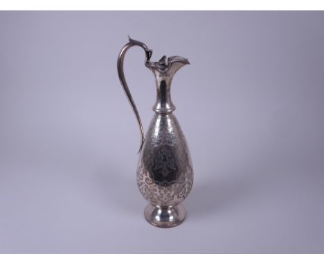 A Victorian silver Claret Jug with scroll engraving and vacant cartouche, beaded rim, hinged cover with leaf finial, London 1