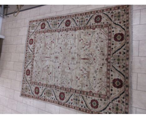 A Persian Carpet with floral motifs on a camel ground, 10ft x 7ft 10in