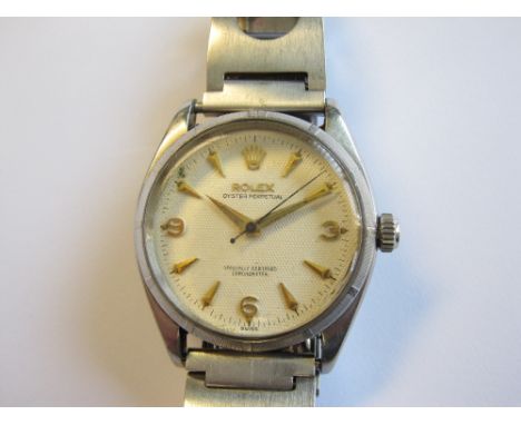 A Gentleman's Rolex Oyster Perpetual Wristwatch, the textured cream dial with arabic numerals at 3, 6 and 9, coronet at 12, t