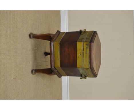 A George III mahogany and brass bound Cellarette, of hexagonal form, caddy-moulded hinged top, lead lining, side handles, on 